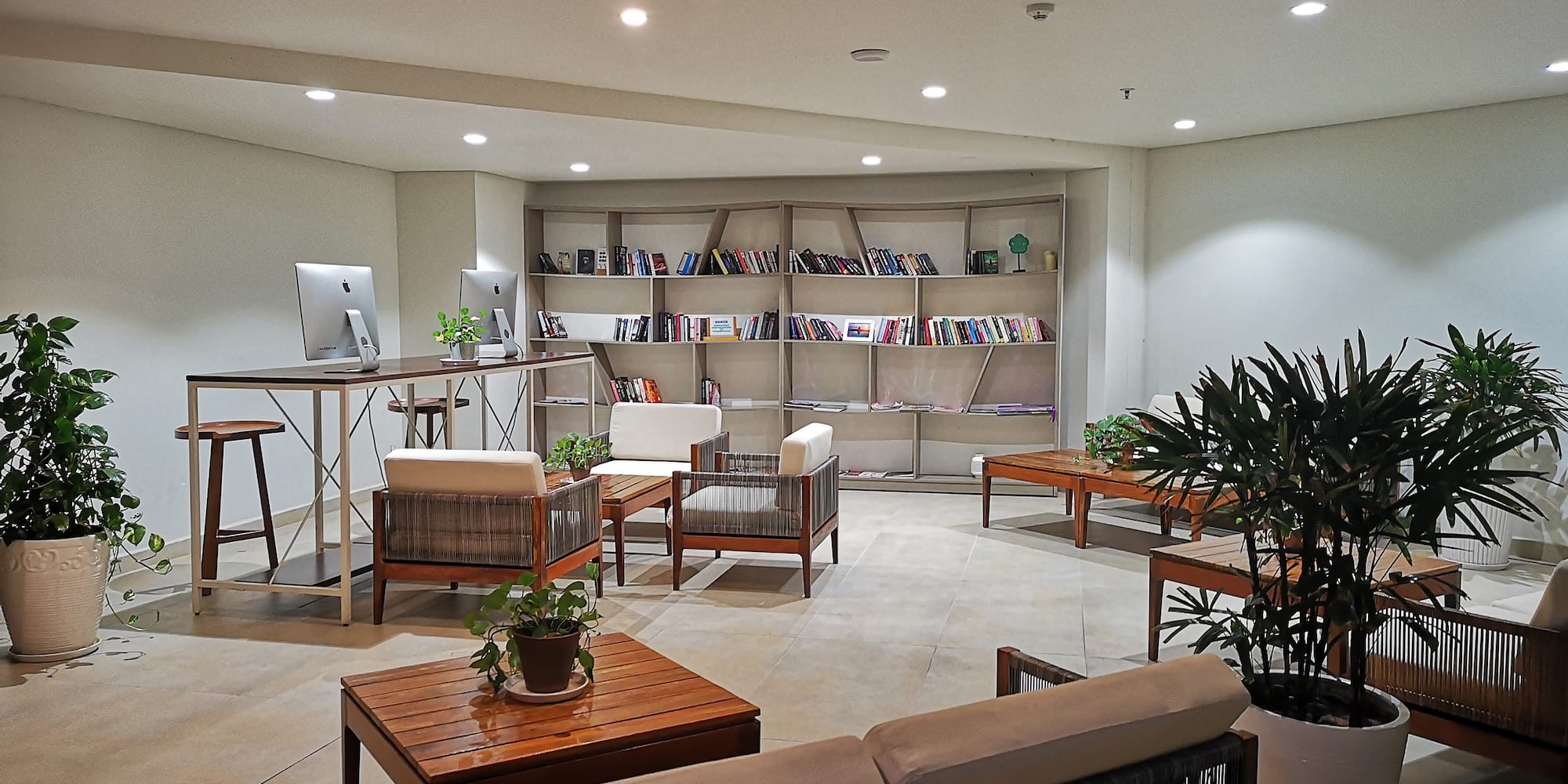 a room with a computer desk and chairs
