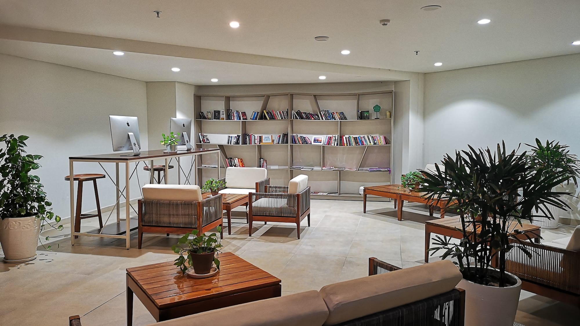 a room with a computer desk and chairs