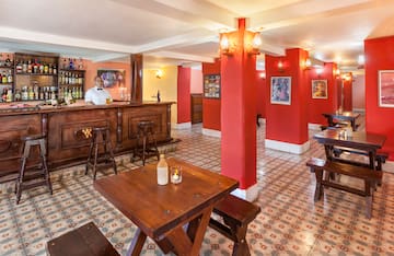 a man behind a counter in a room with red walls
