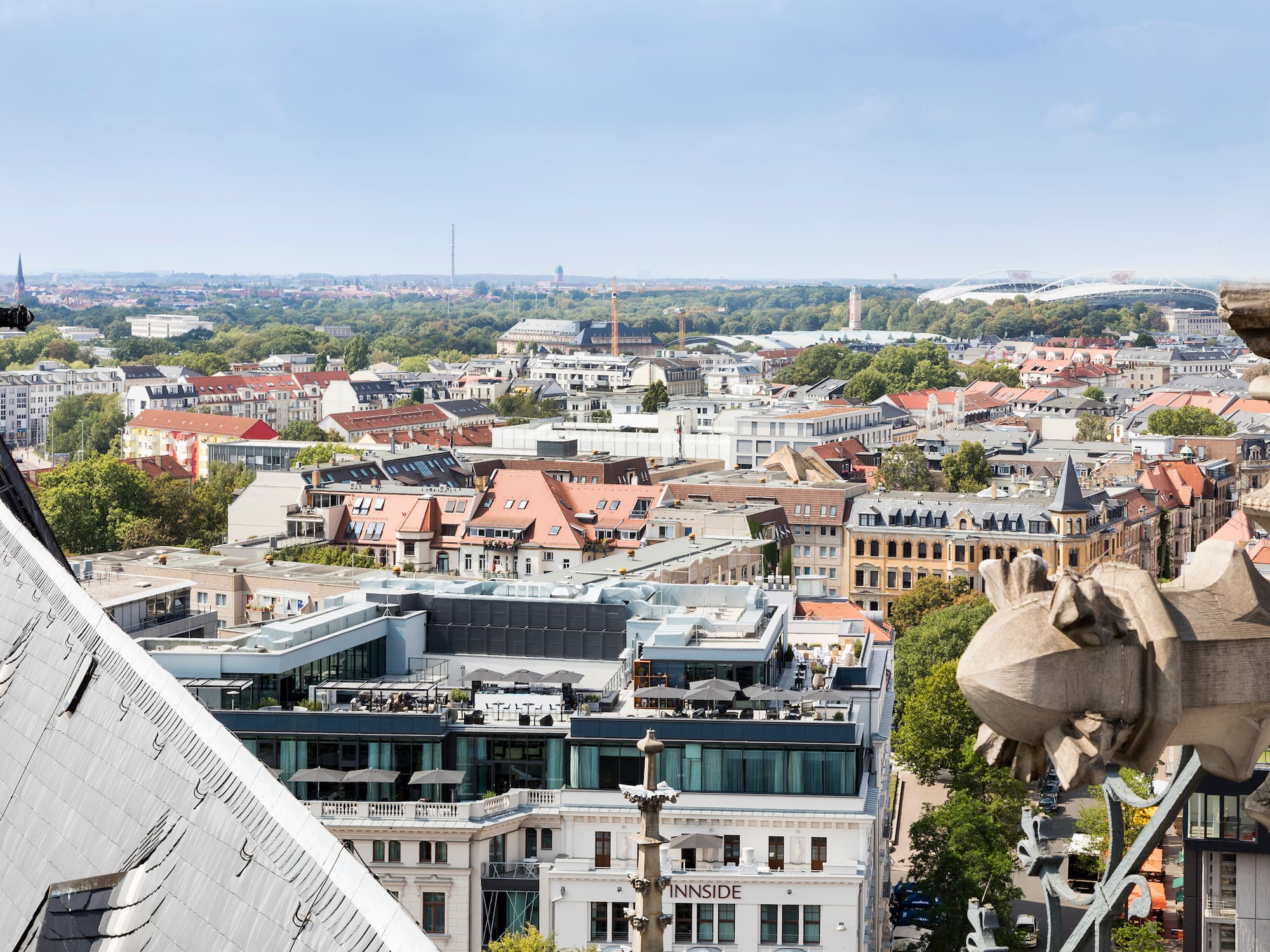 a city with a statue on the roof