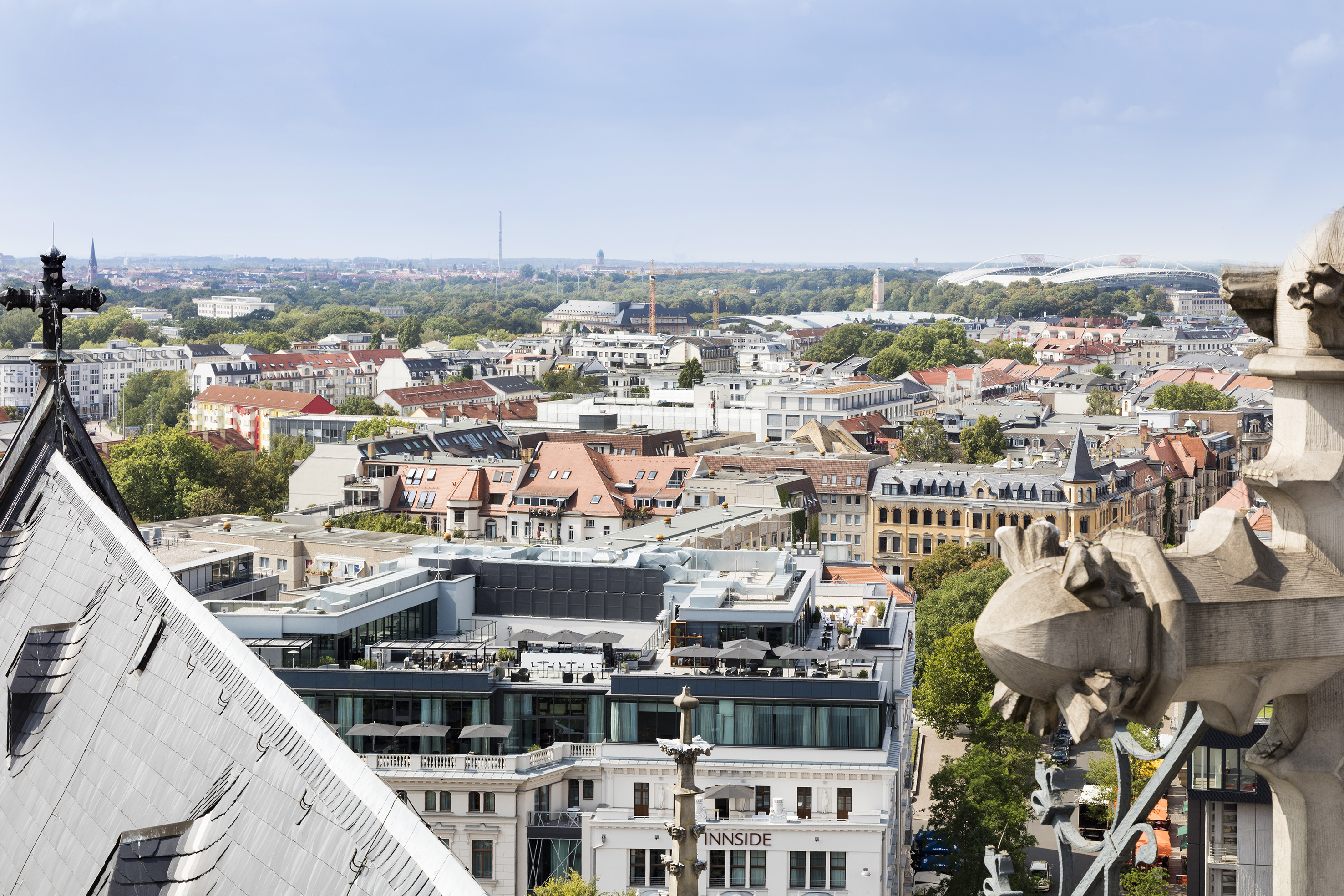 Leipzig city overview with stadium, rooftops, and Innside Hotel.