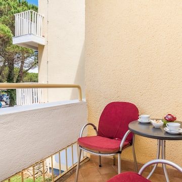 a table and chair on a balcony