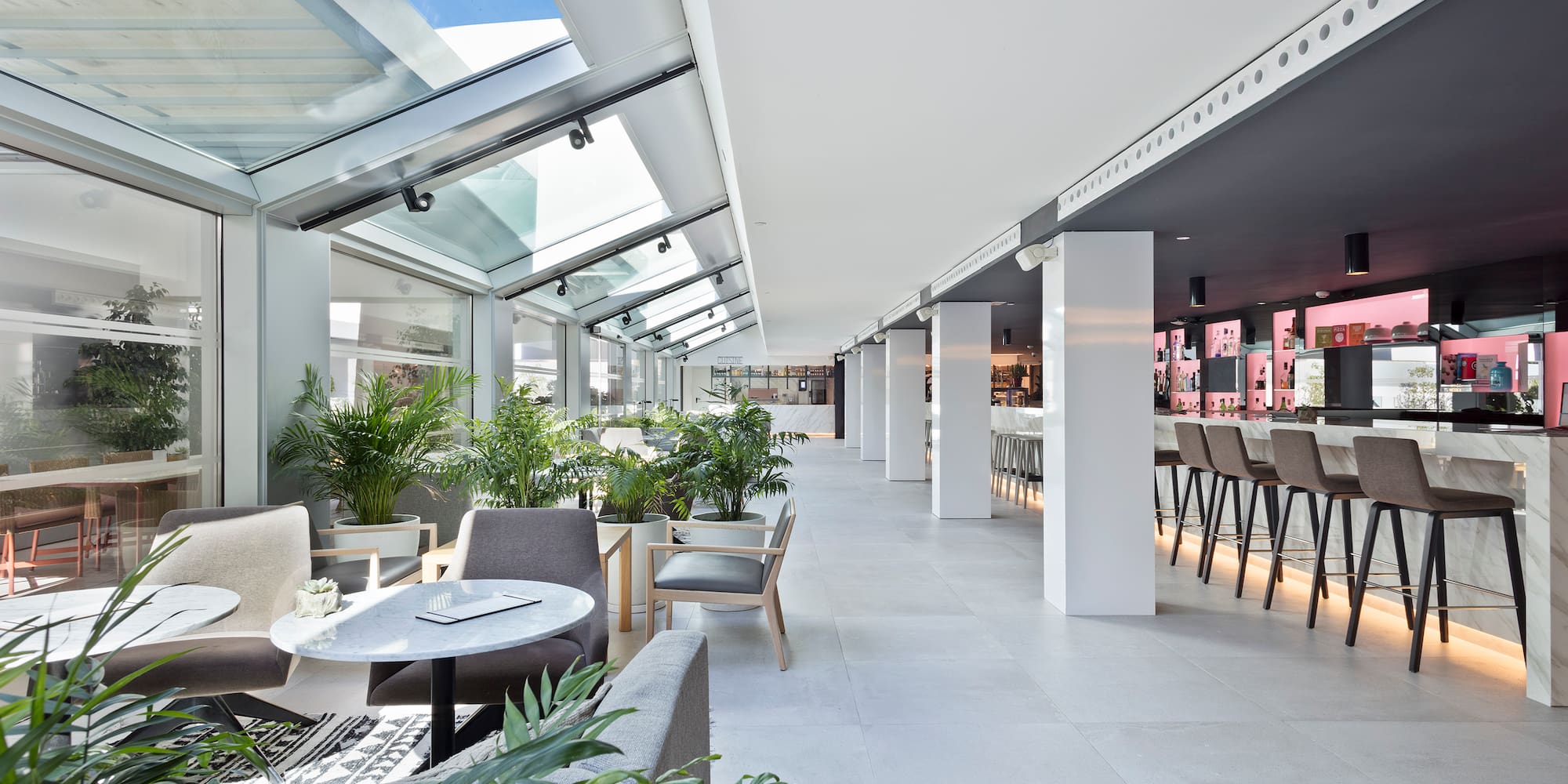 a room with tables and chairs and plants