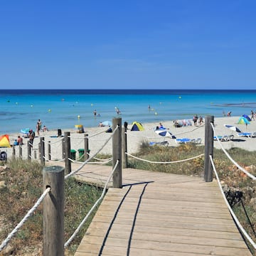 a wooden walkway leading to a beach