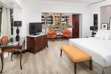 a room with a bed and a television