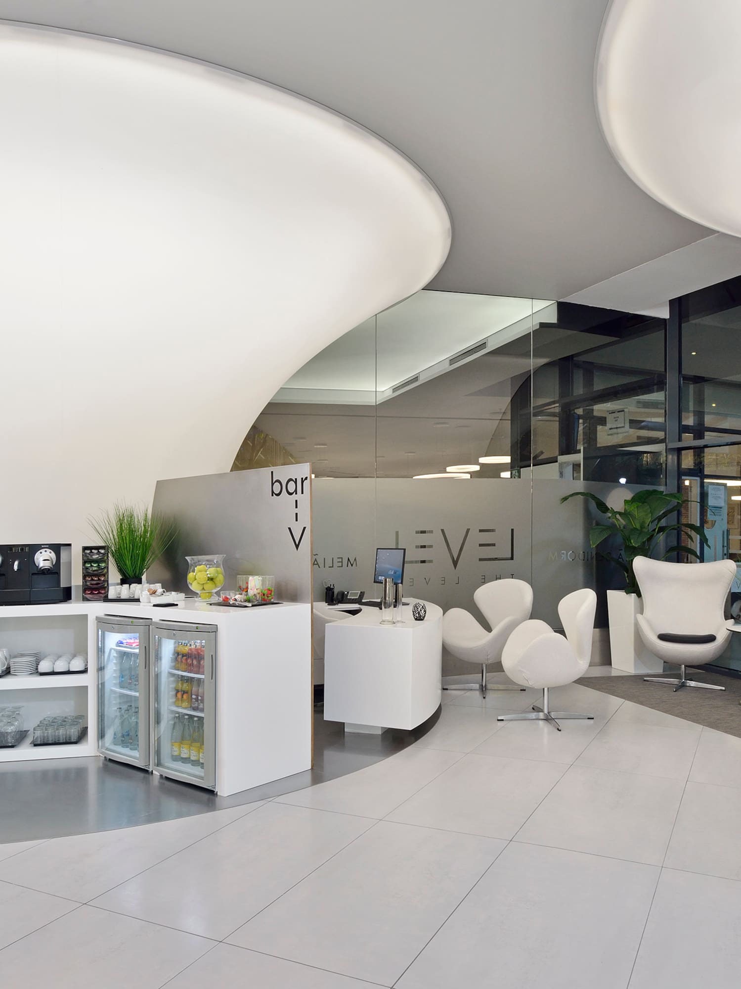 a room with white chairs and a white counter