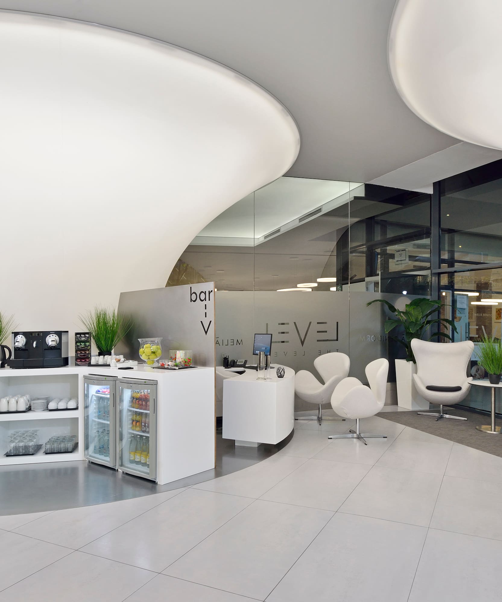 a room with white chairs and a white counter