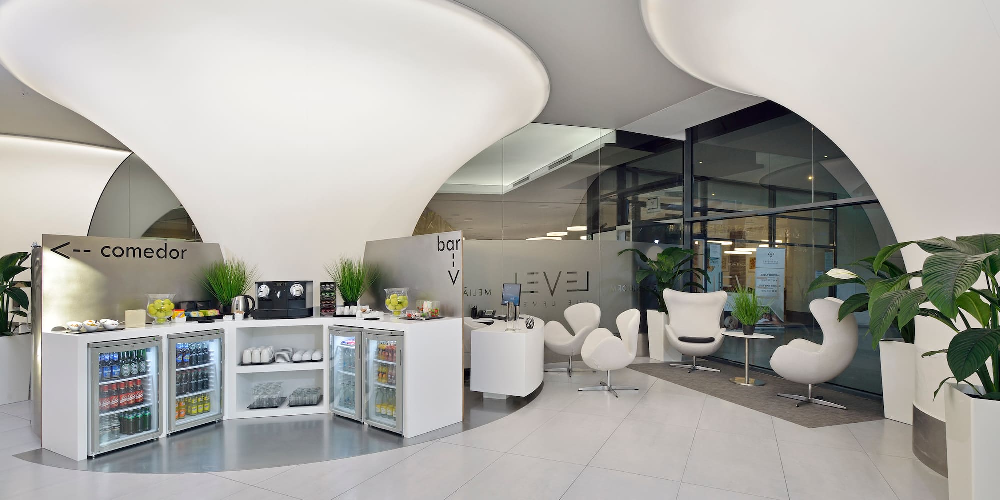 a room with white chairs and a white counter