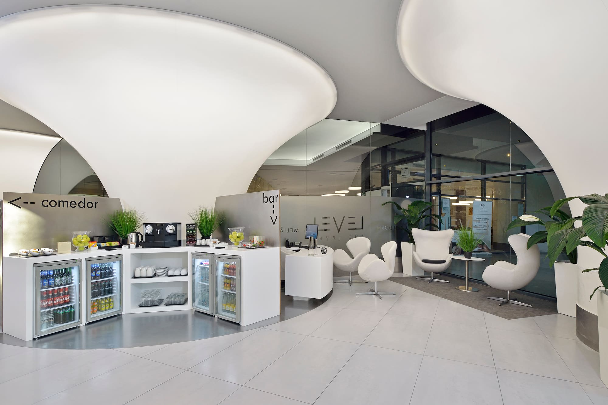 a room with white chairs and a white counter