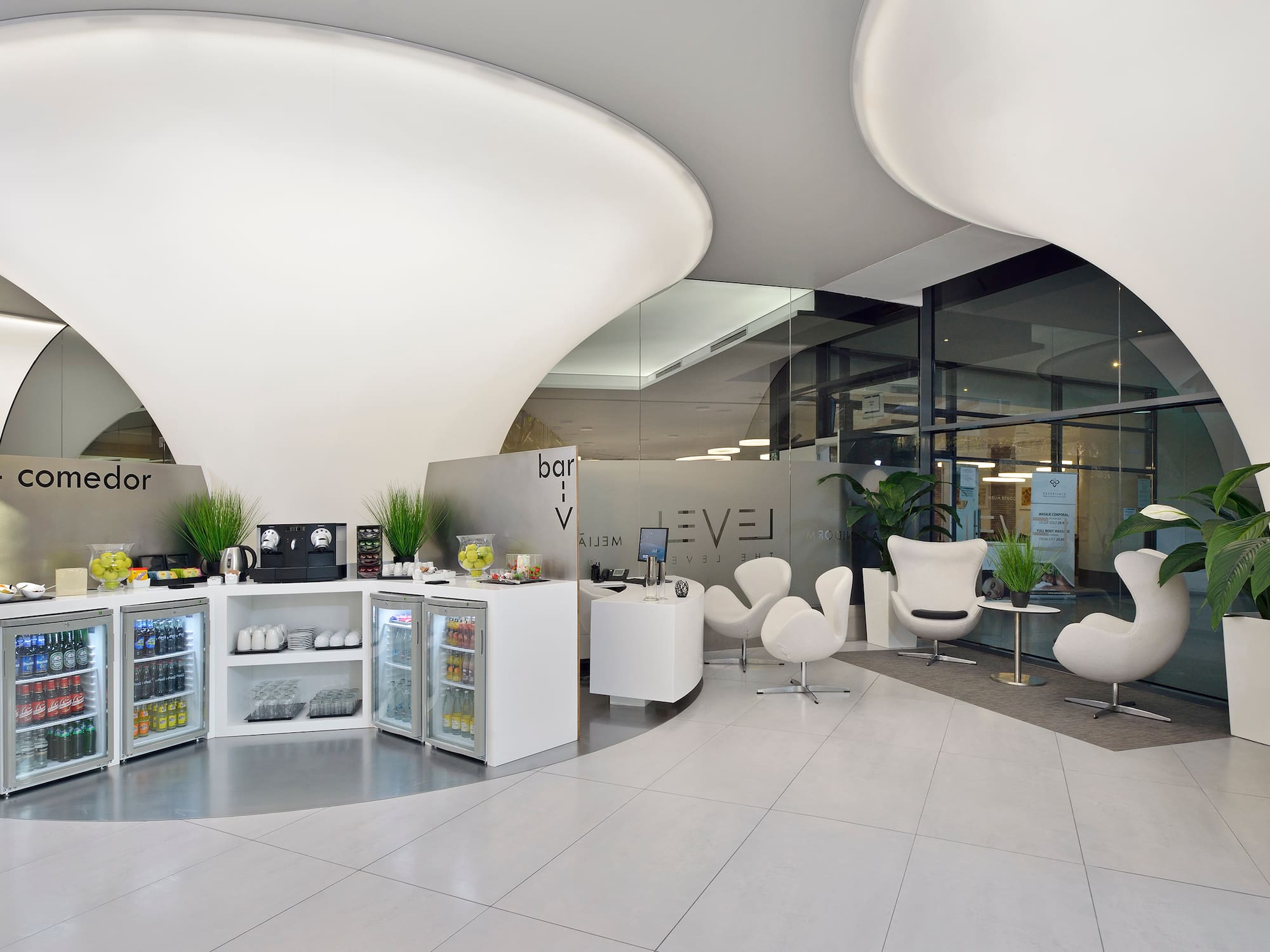 a room with white chairs and a white counter