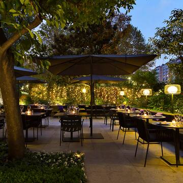 a outdoor restaurant with tables and umbrellas