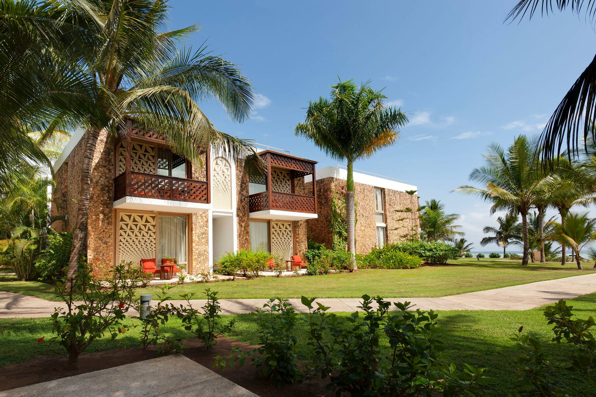 a building with palm trees and grass