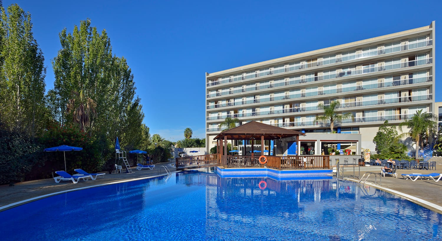 a swimming pool with a building in the background