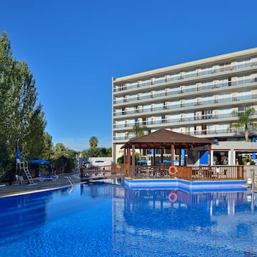 a swimming pool with a building in the background