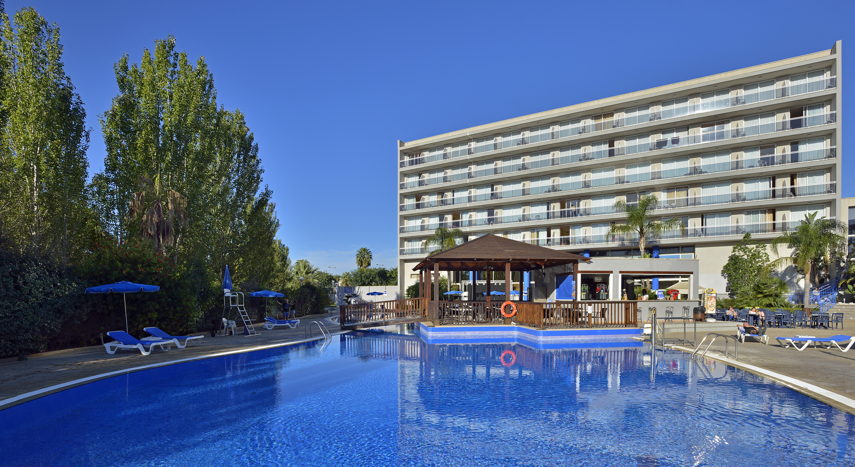 a swimming pool with a building in the background