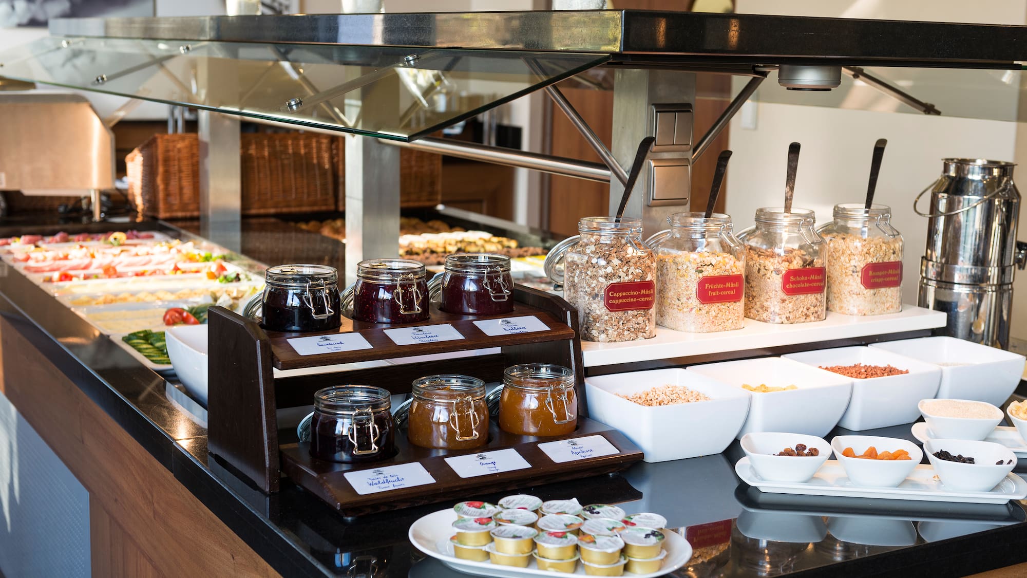 a buffet table with food and jars of jam