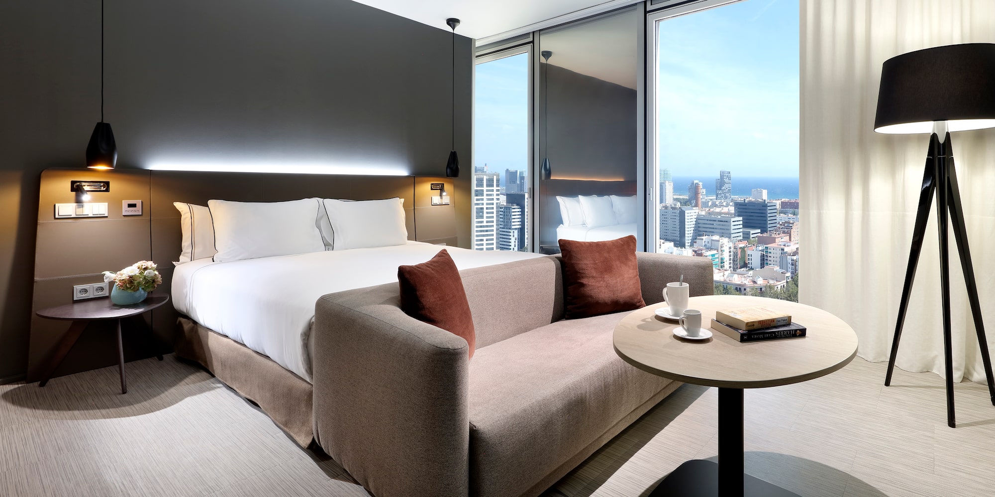 a hotel room with a couch and a table