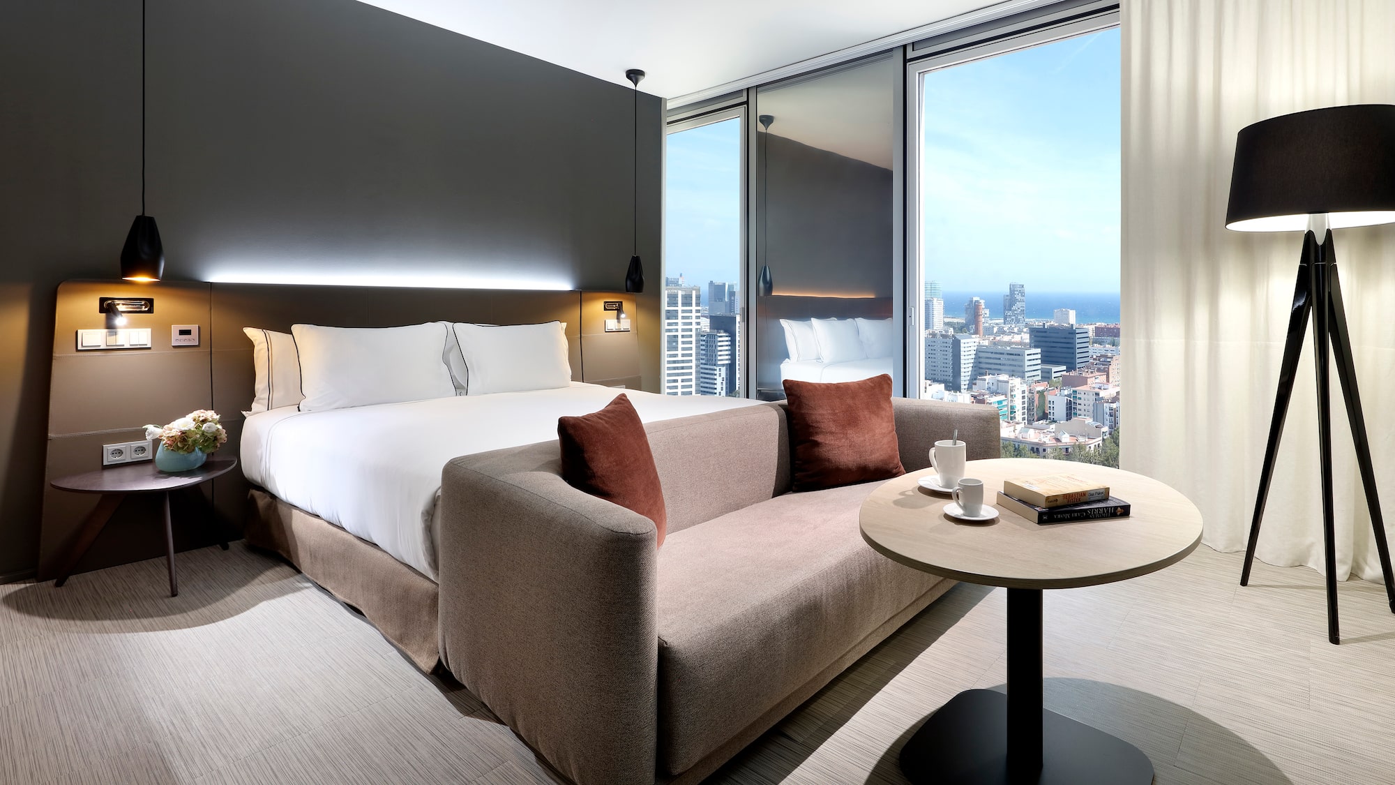 a hotel room with a couch and a table