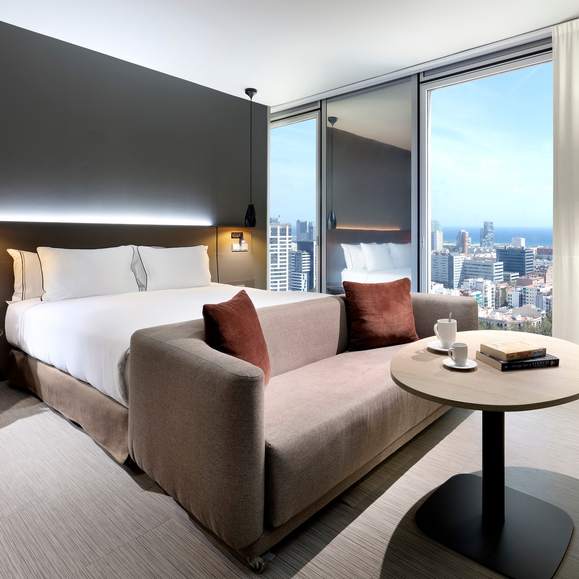 a hotel room with a couch and a table