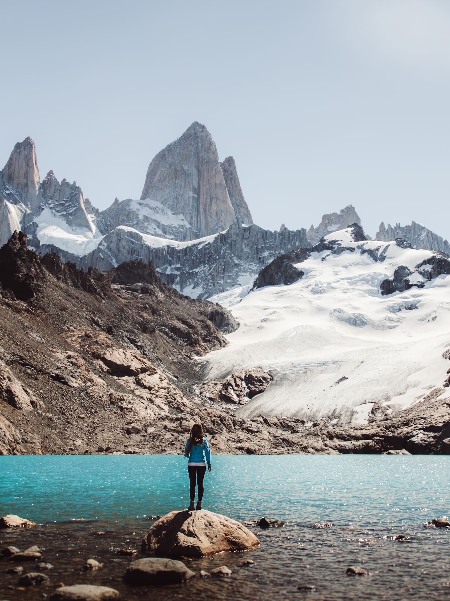 a person standing on a rock in front of Fitz Roy