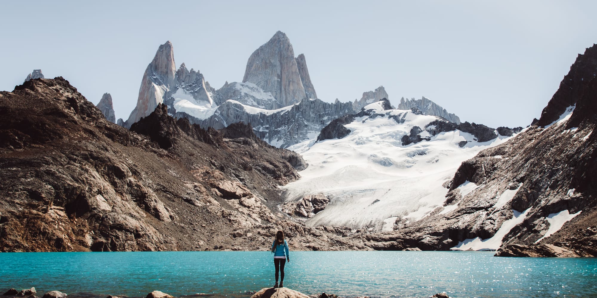 a person standing on a rock in front of Fitz Roy