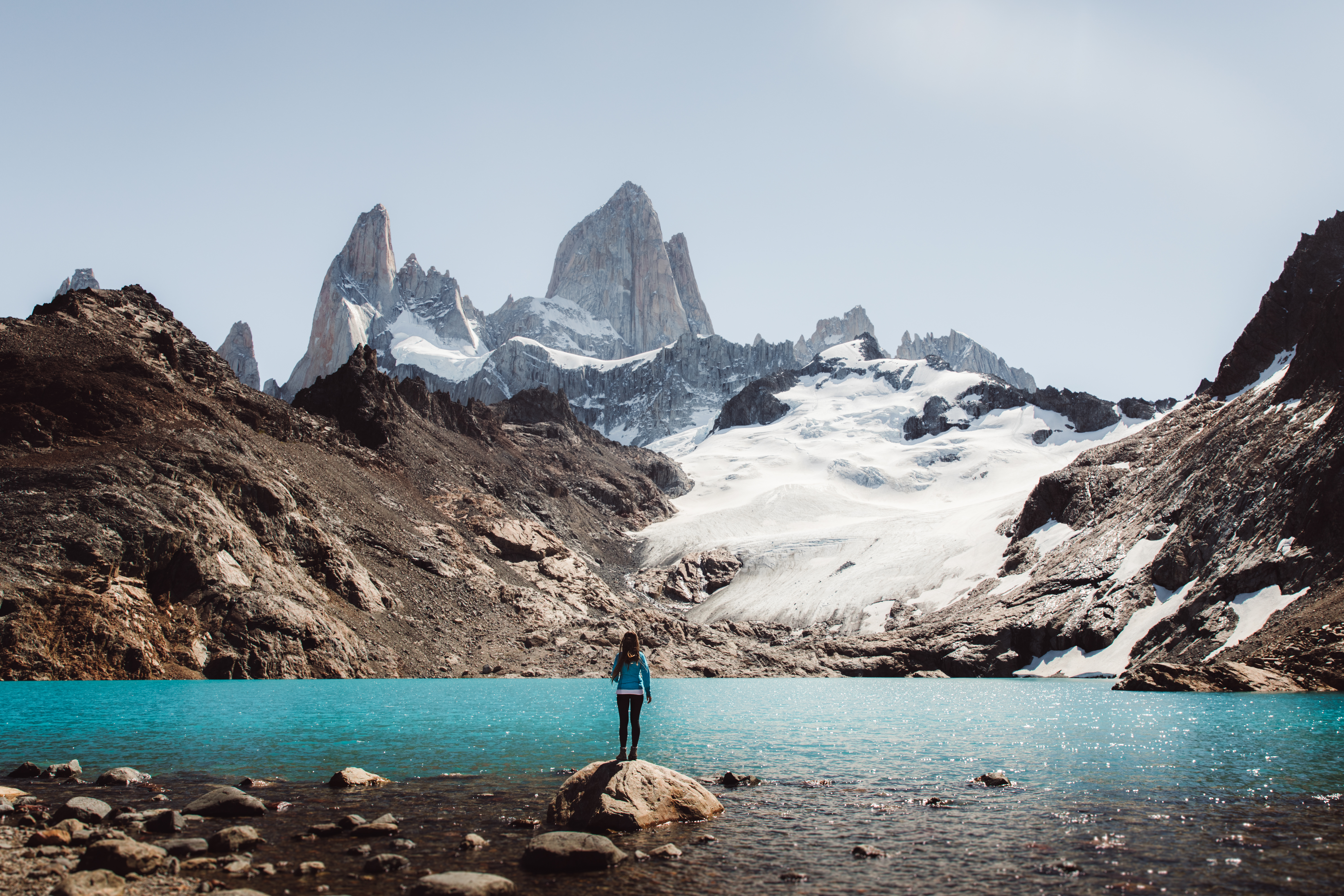 a person standing on a rock in front of Fitz Roy