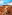 Aerial Fuerteventura mountain landscape with winding road and distant ocean view.