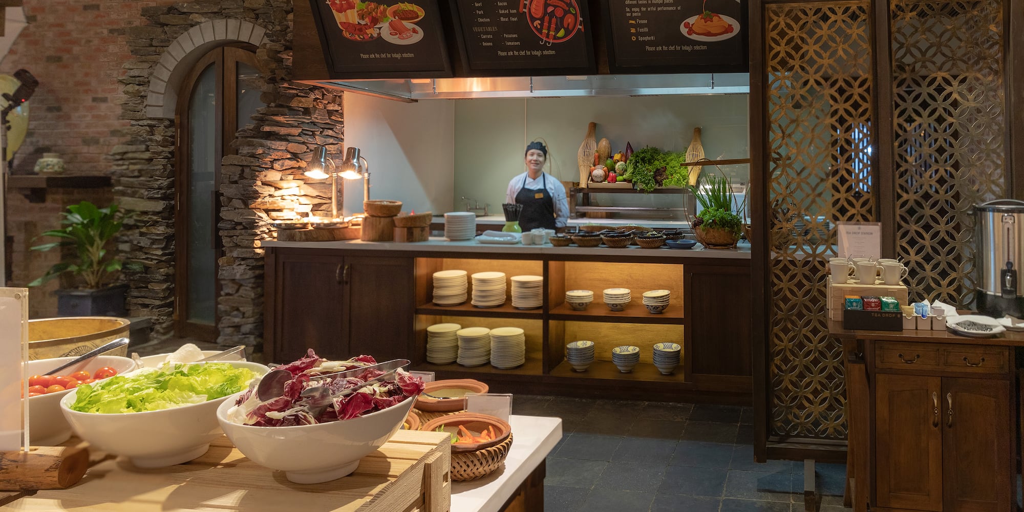 a woman standing behind a counter in a restaurant