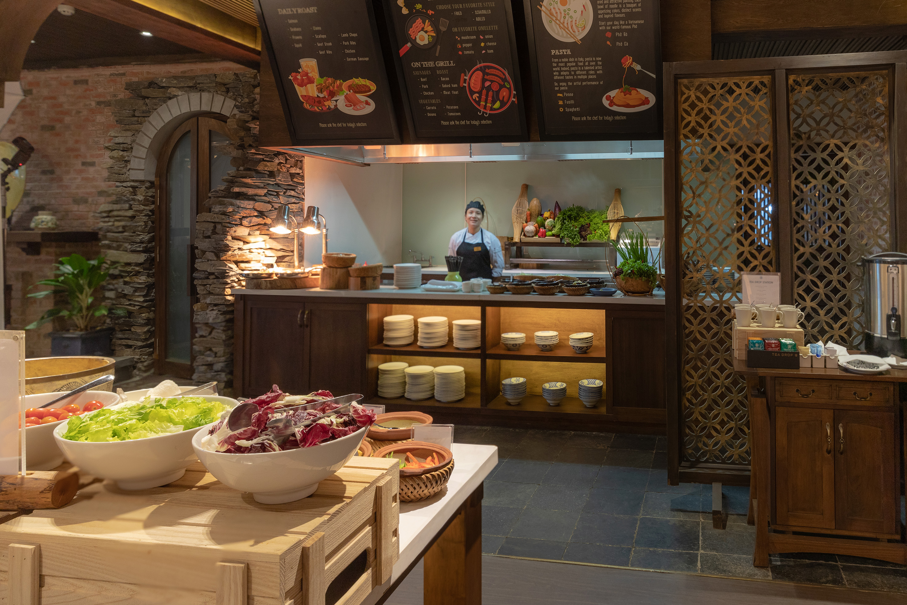 a woman standing behind a counter in a restaurant