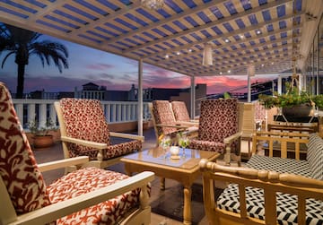 a patio with chairs and a table