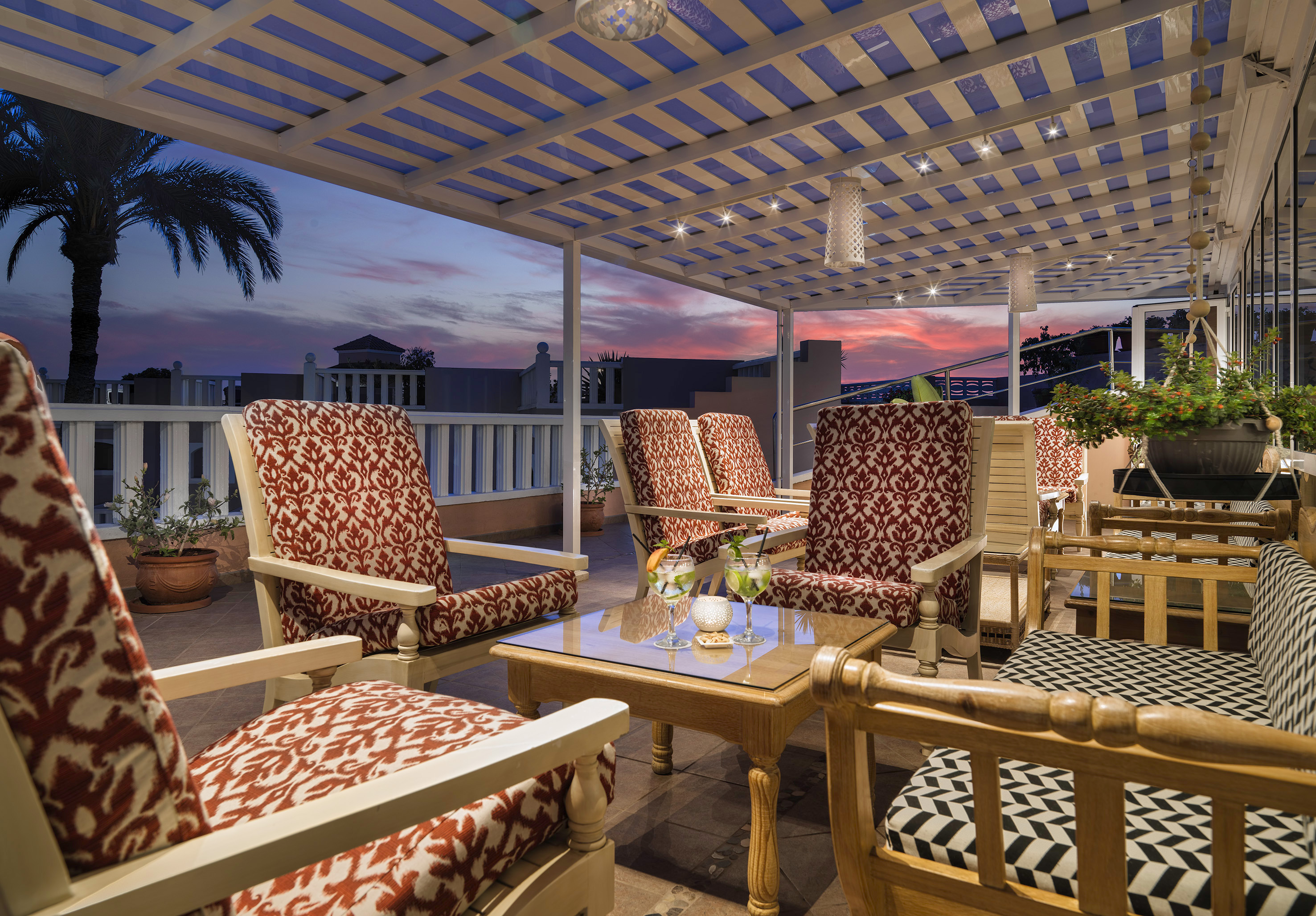 a patio with chairs and a table