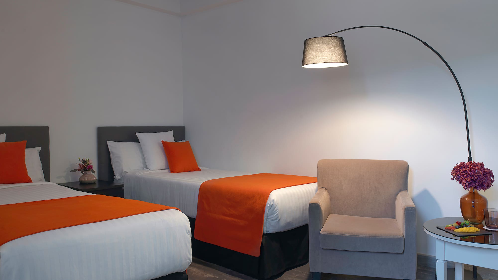 a room with two beds and a lamp