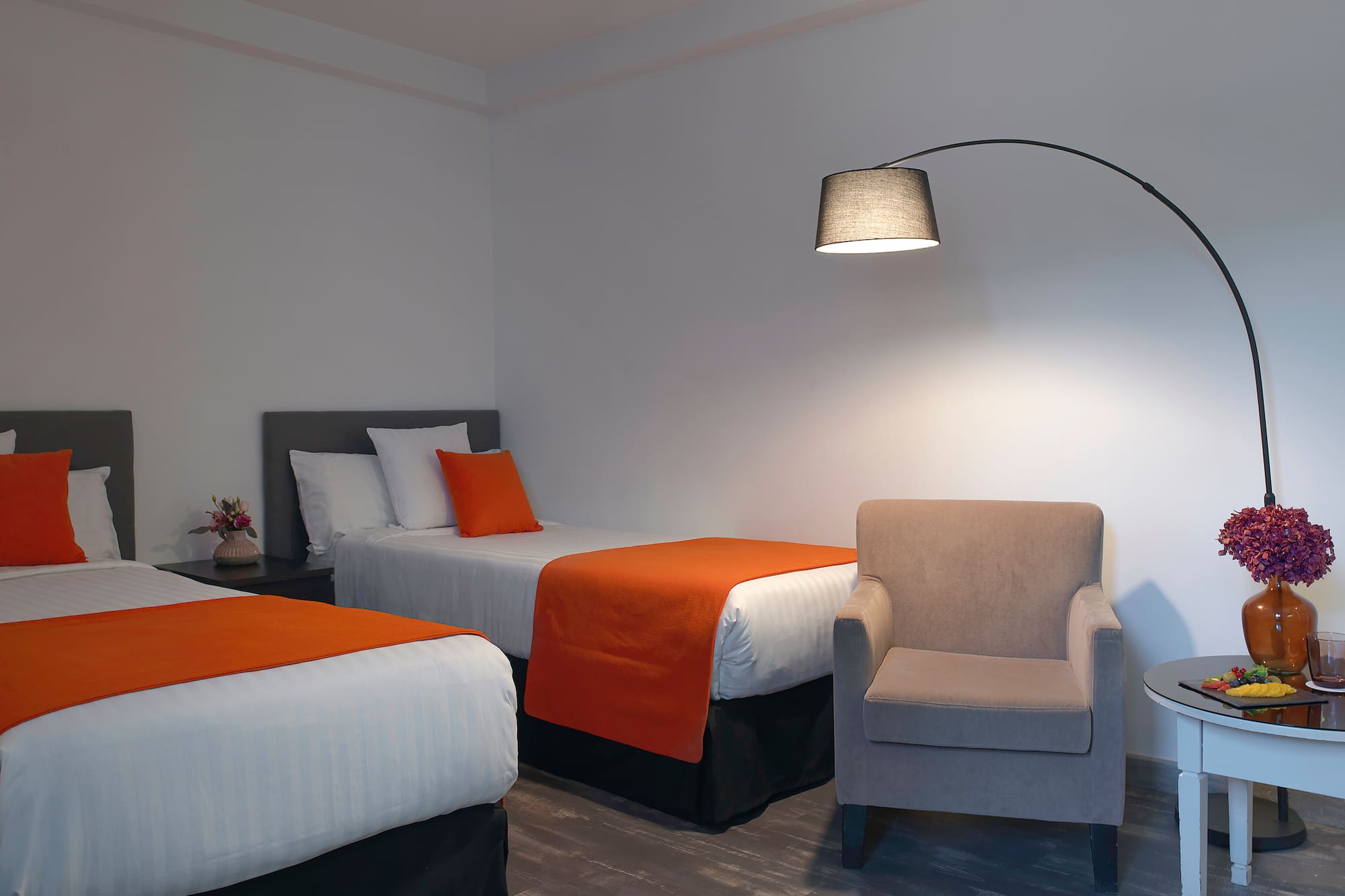 a room with two beds and a lamp