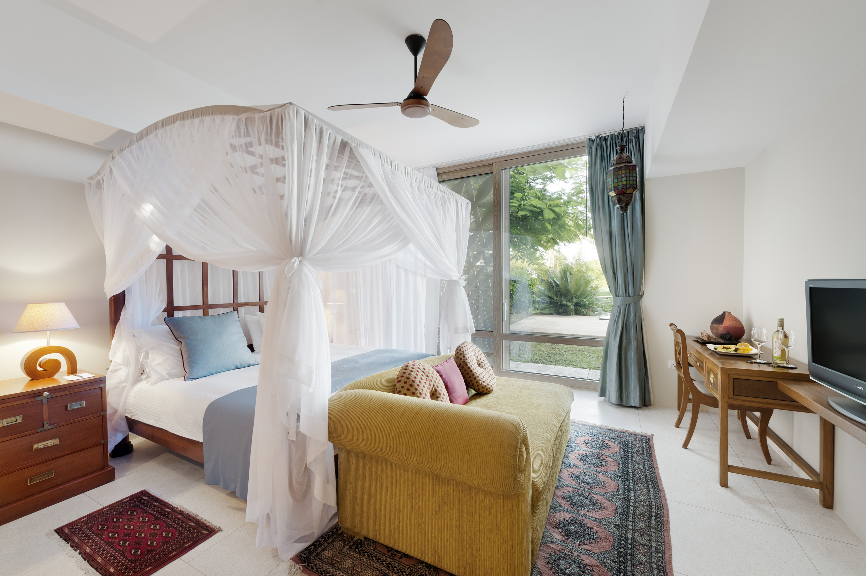 a bedroom with a canopy bed and a couch