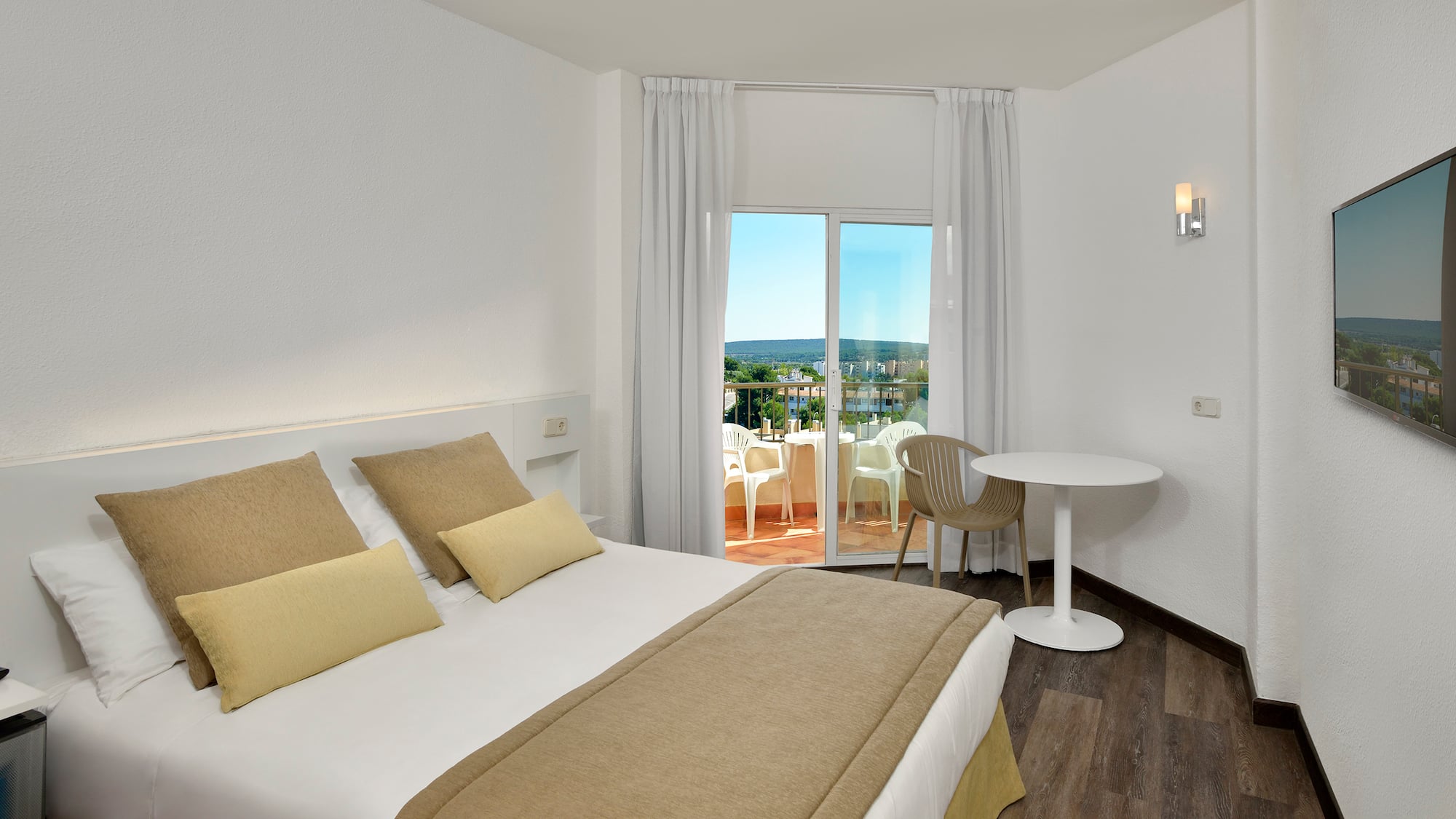 a bedroom with a table and chairs