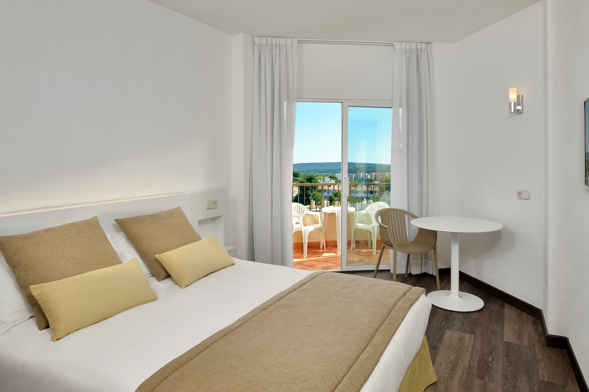 a bedroom with a table and chairs