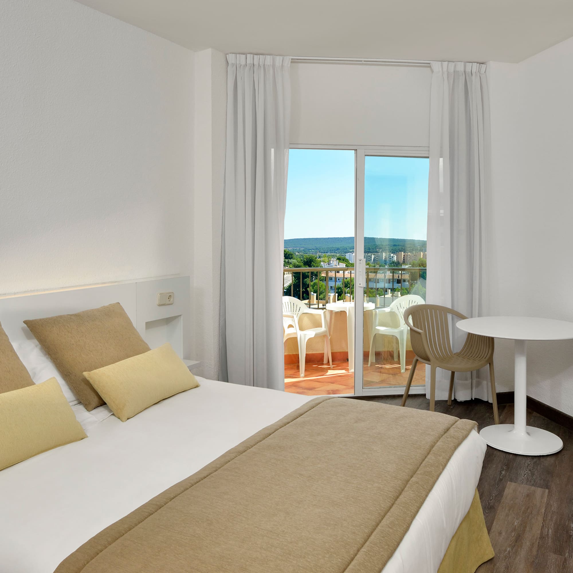 a bedroom with a table and chairs