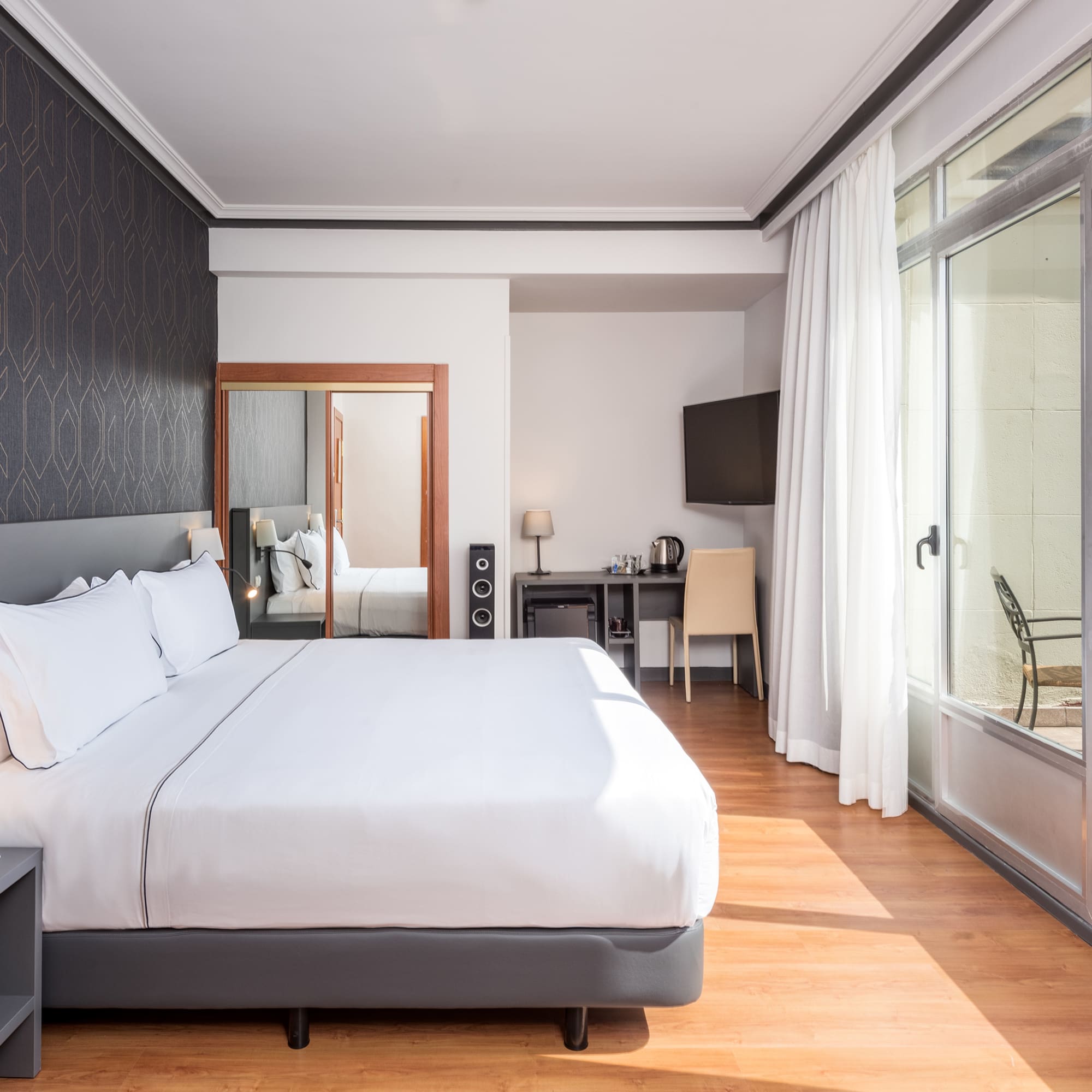 a bedroom with a bed and a mirror