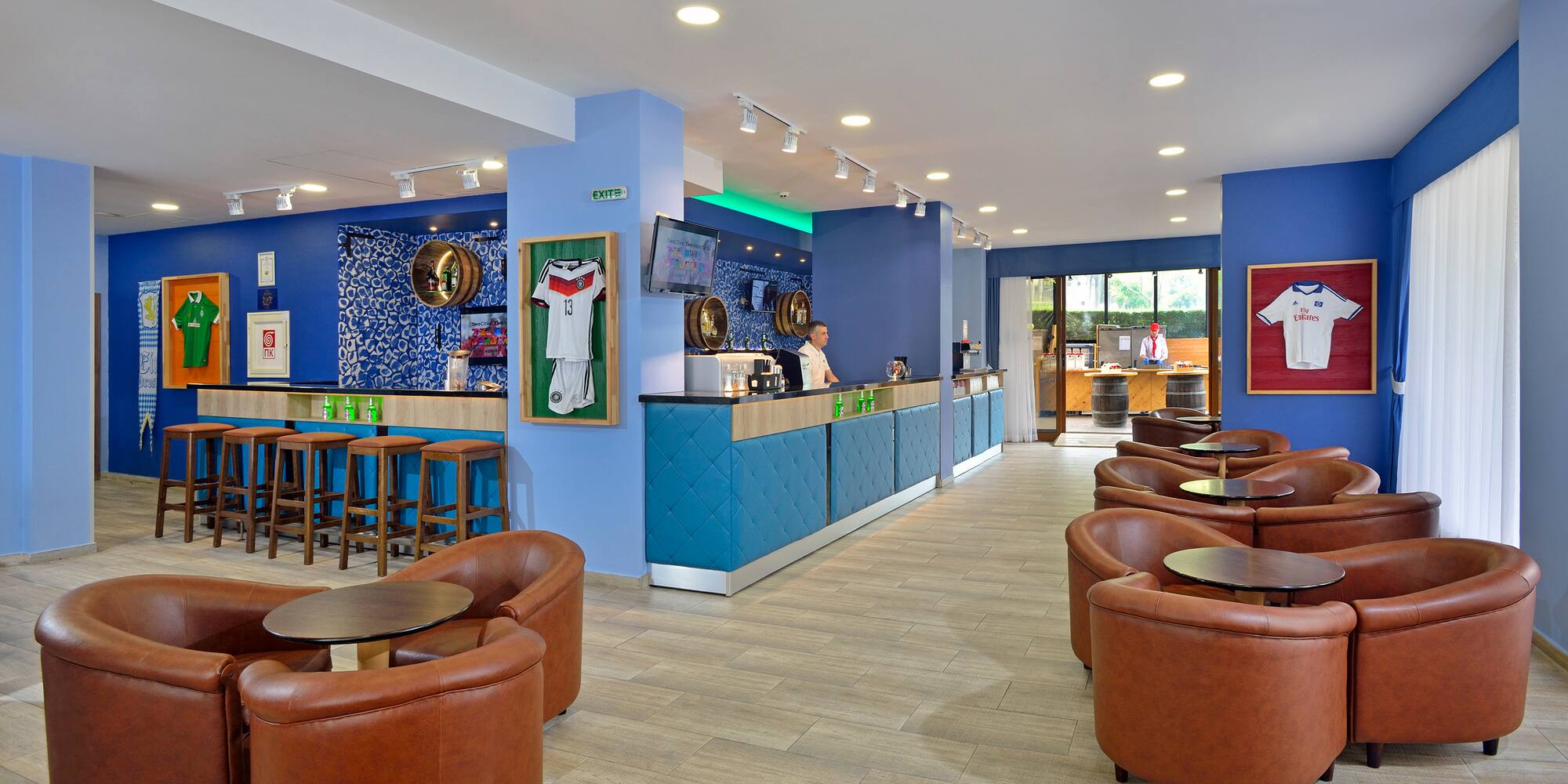 a room with blue walls and tables and chairs