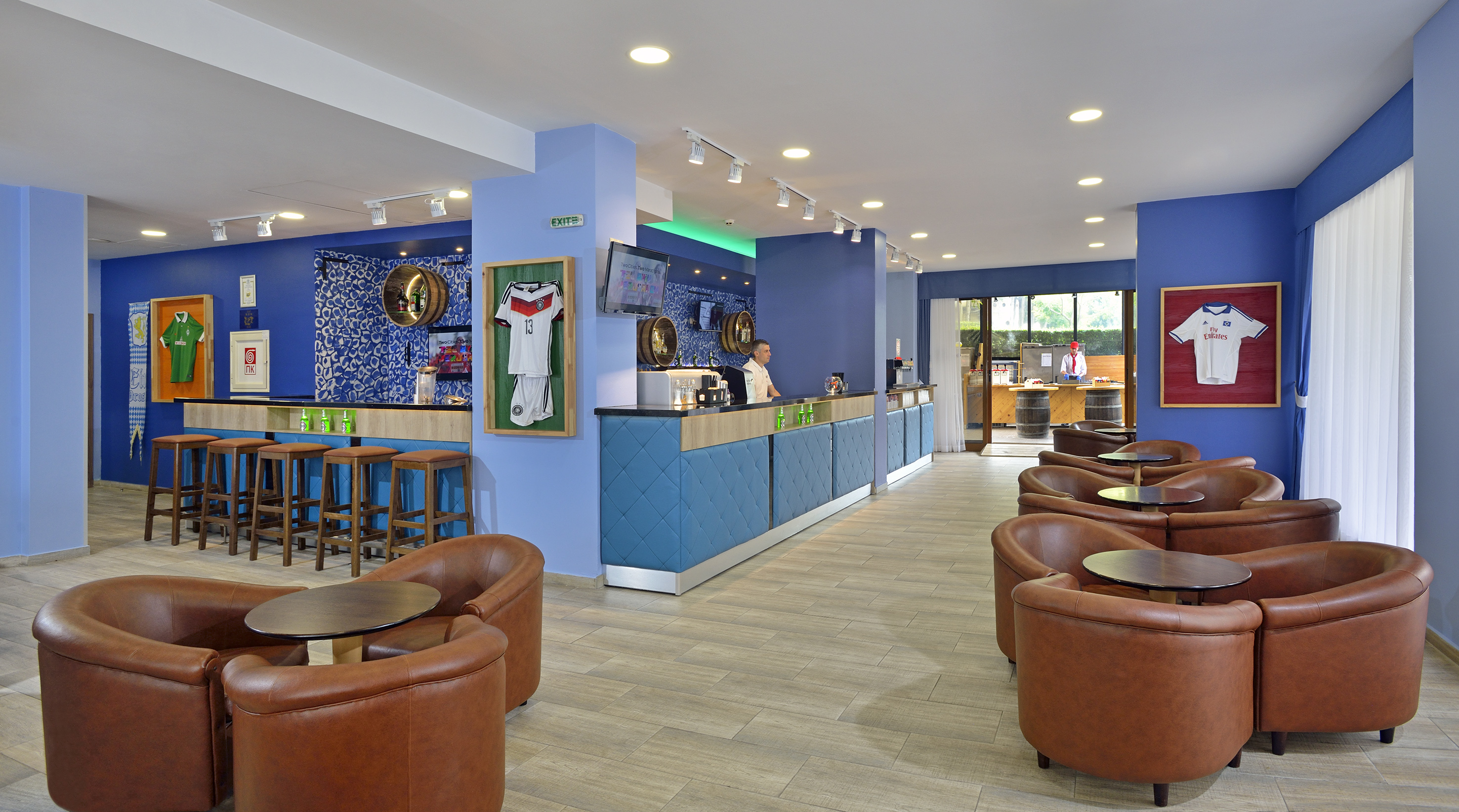 a room with blue walls and tables and chairs