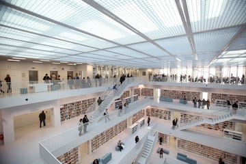 a large white building with many people