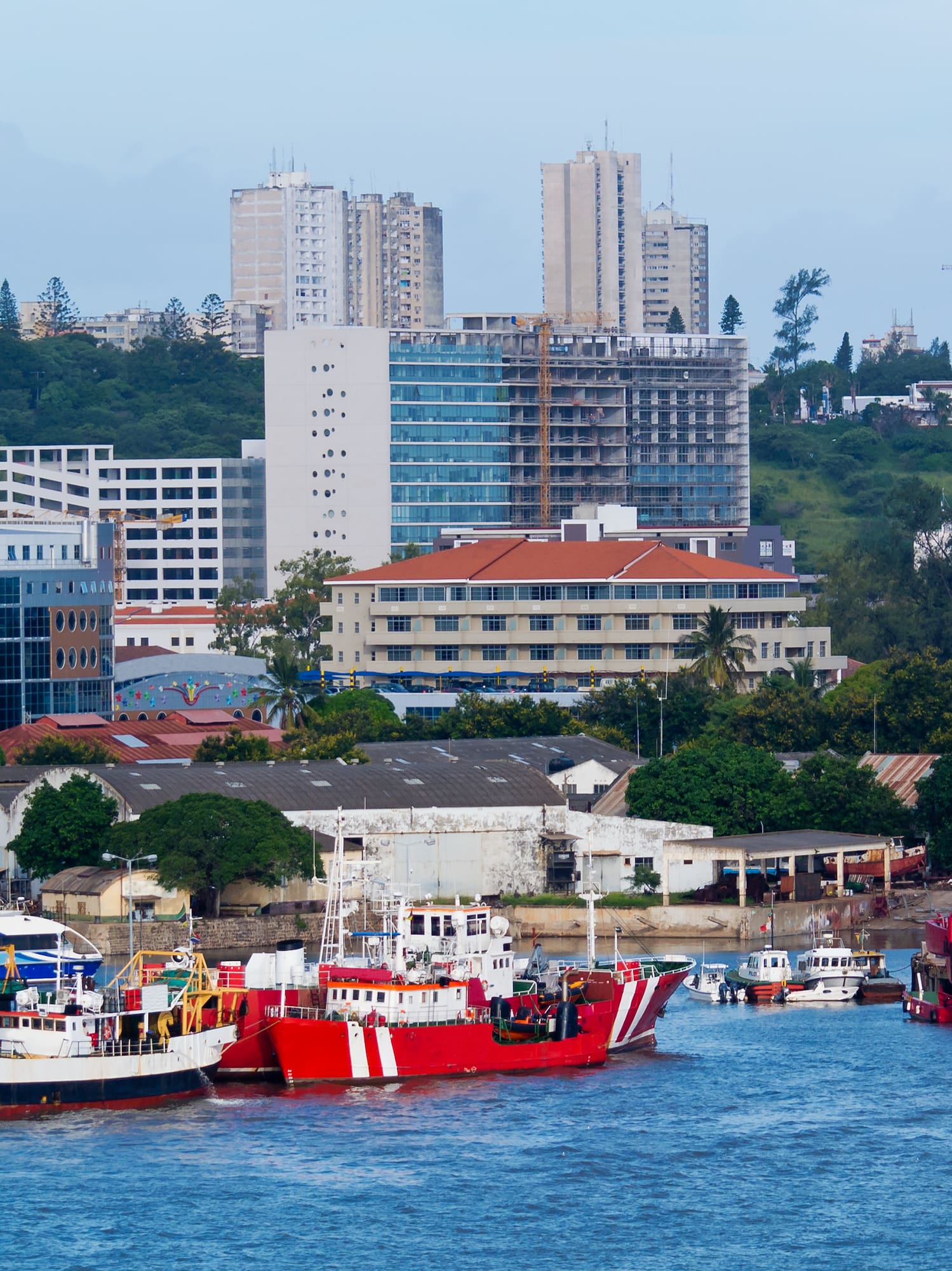 boats in a harbor with buildings in the background