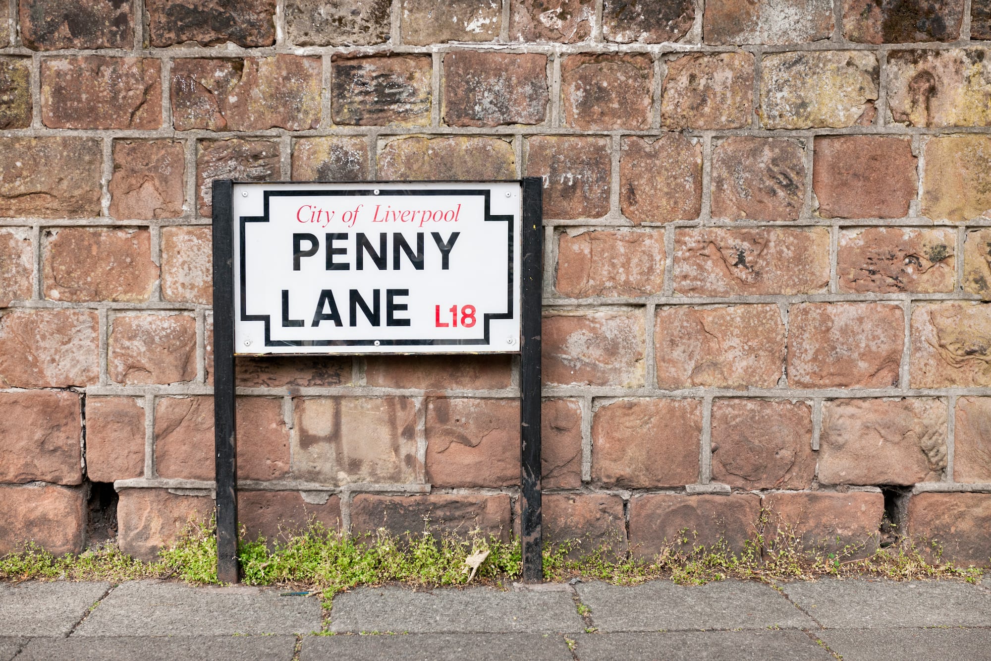 a sign on a brick wall