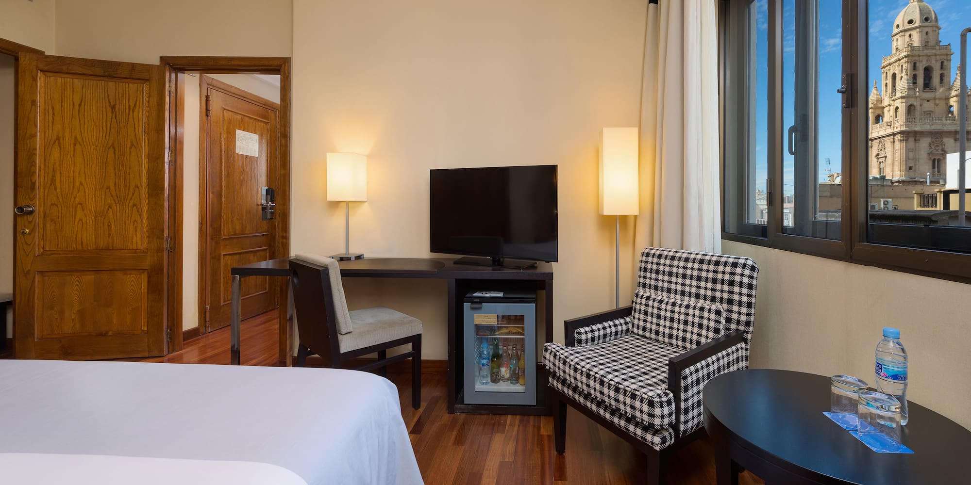 a room with a bed and a television