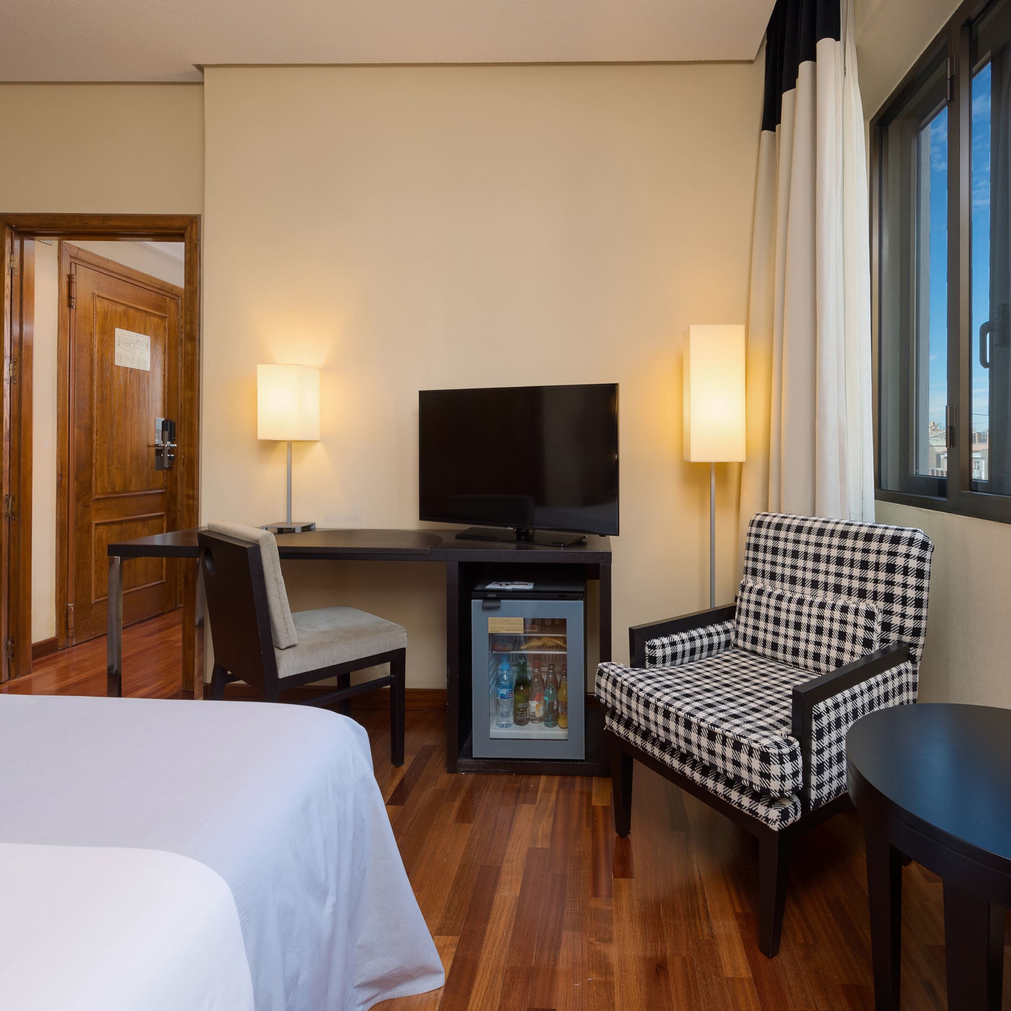 a room with a bed and a television