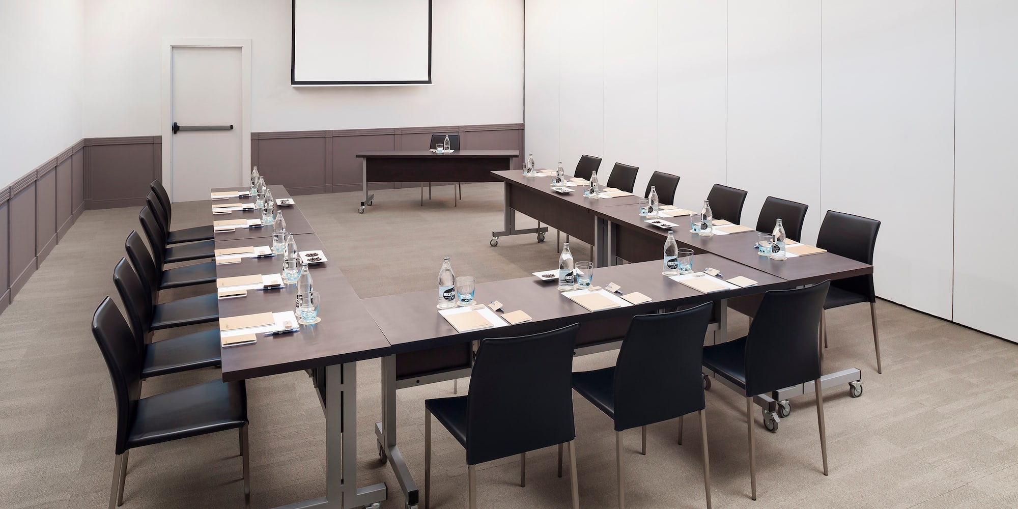 a conference room with tables and chairs
