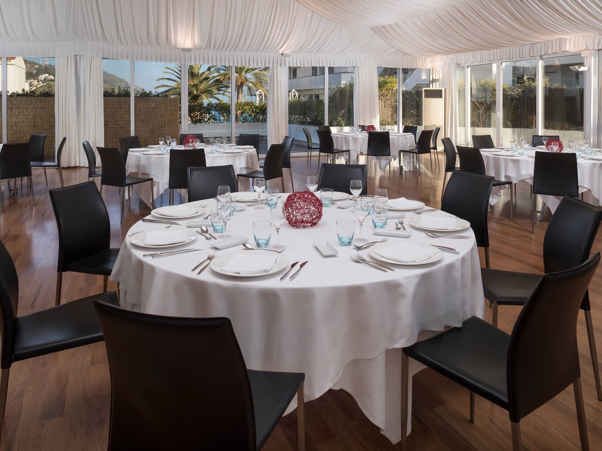 a round table set up for a dinner party