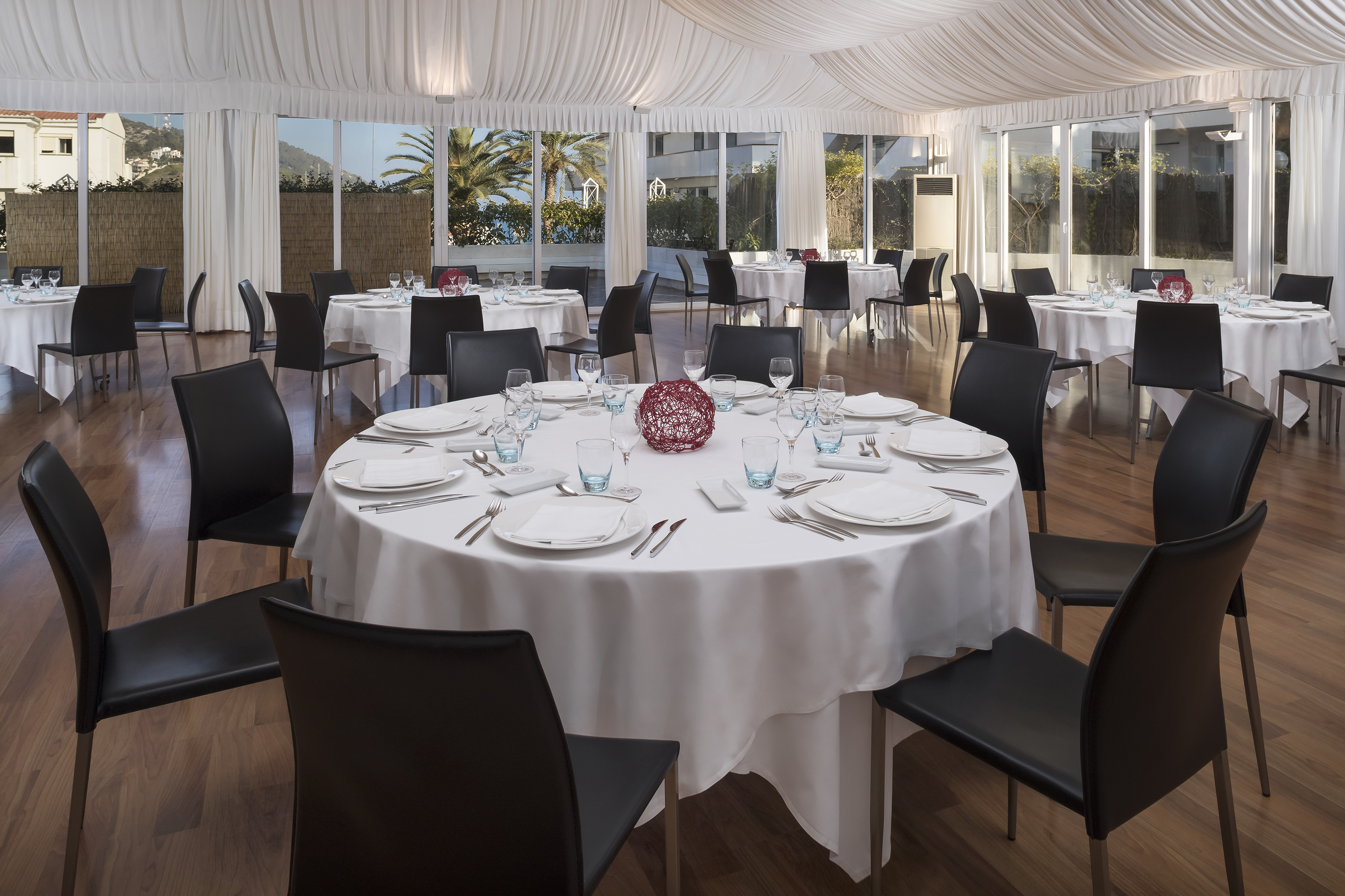 a round table set up for a dinner party