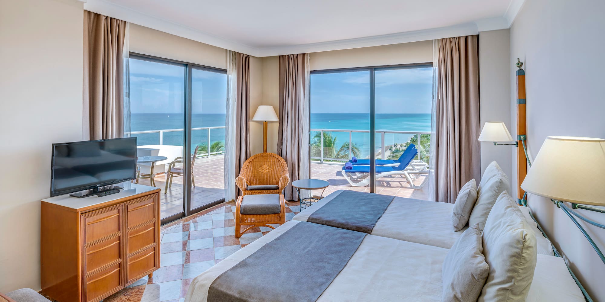 a room with two beds and a television