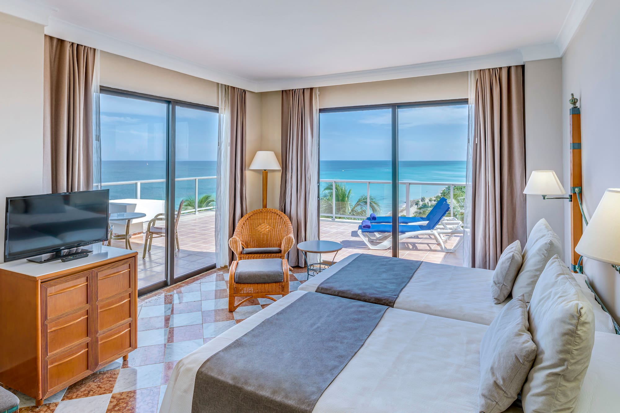 a room with two beds and a television